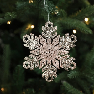 Rose gold and silver glitter snowflake ornament hanging on a festive Christmas tree