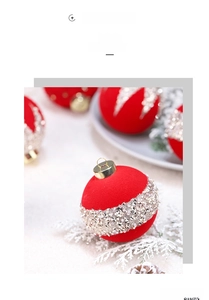 Close-up of red flocked Christmas ball with sequin diamond belt on snowy branches