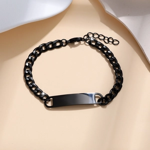 Macro shot of black stainless steel chain bracelet with blank rectangular ID plate detail