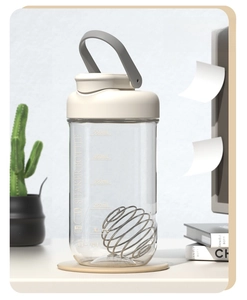 Detail of 750ml protein shaker bottle with clear scale and metal mixing ball inside