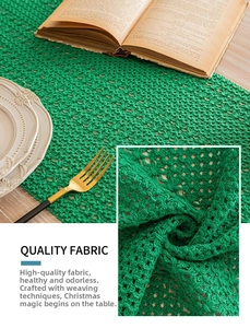 Detail of dark green crochet table runner with hollow grid patterns for Christmas decor