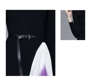 Détail de la robe en maille noire avec tissu plissé dégradé violet et ceinture fine