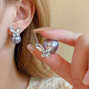 Elegant gold-plated butterfly stud earrings with sparkling zircon and lavender pearls