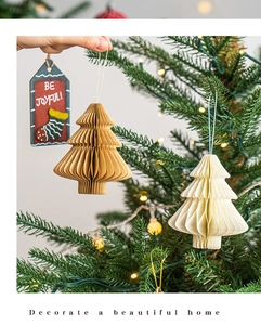 Detail of paper accordion Christmas tree hanging ornaments in beige and kraft brown colors
