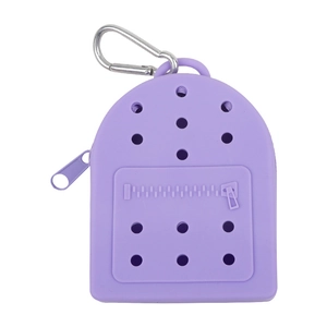 Purple silicone mini backpack coin purse with holes and metal carabiner on white background