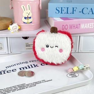 Close-up of a cute plush apple coin purse with embroidered expression and fruit stem