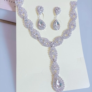 Silver twisted crystal necklace and pear-shaped drop earrings jewelry set on display