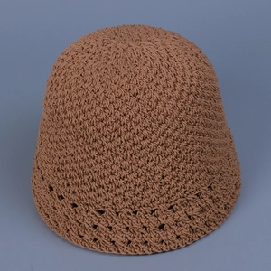 Close-up detail of the brown crochet fisherman hat showing hollow knit patterns and texture