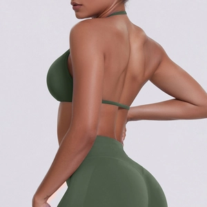 Detail view of seamless halter neck sports bra and leggings set in dark green