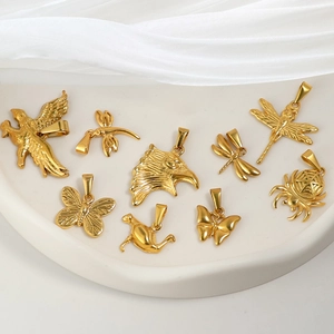 Detail of assorted 24K gold-plated animal pendants including butterfly and dragonfly