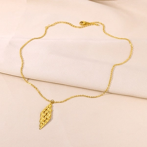 Macro detail of 18K gold stainless steel necklace with tiered 3D heart pendant