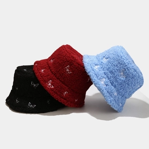 Teddy fleece bucket hat with butterfly embroidery in black, red, and blue colors