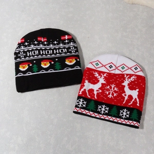 Matching Christmas knit beanies with Santa Claus and reindeer patterns in red and black