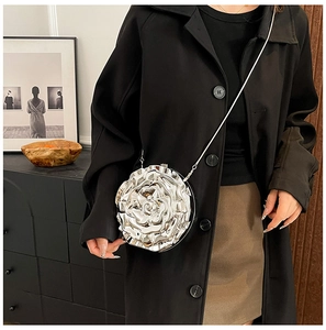 Close-up of a silver camellia shaped metallic crossbody bag with stylish chain strap