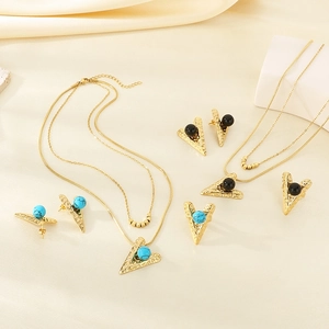 Detailed shot of gold stainless steel jewelry set with turquoise and black beads
