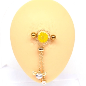 Gold nipple ring with yellow daisy and winged heart pendant on silicone model