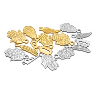 Golden and silver stainless steel charms including Hamsa, feather, and blade for DIY jewelry