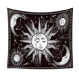 Detailed view of bohemian tapestry featuring mystical sun, moon, and astrology patterns