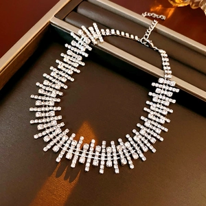Macro shot of silver diamond-encrusted irregular fringe necklace in a premium jewelry box