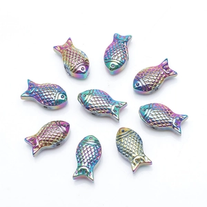 Detailed view of nine rainbow-plated metal fish pendants arranged for DIY jewelry making