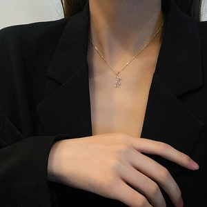 Elegant gold bear pendant necklace with sparkling diamonds on a delicate long chain