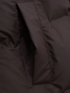 Detailed close-up showing pocket stitching on a deep brown padded long parka coat