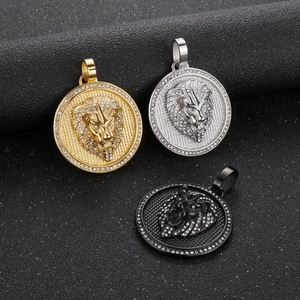 Detailed close-up of lion head round pendants in gold, silver, and black with zircon inlay