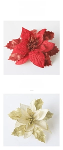 Detail of red and champagne gold artificial poinsettia flowers with glitter coating