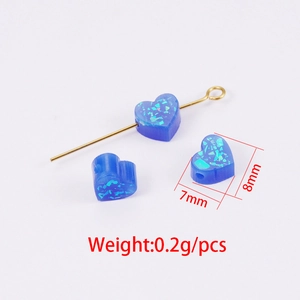 Macro detail of 8mm blue heart synthetic opal bead with 7mm width and 1.5mm hole