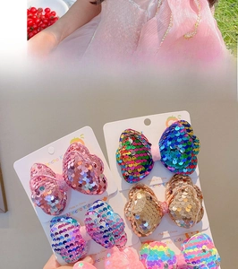 Detail of colorful sequined bow hair clips for girls in various pastel glitter finishes