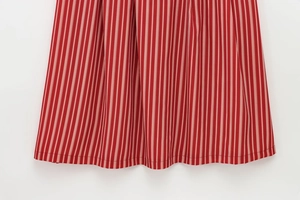 Detail of red and white vertical stripes on dress with professional double-stitched hemline