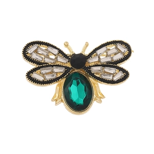 Artistic golden bee brooch with a large green gemstone and crystal-encrusted wings