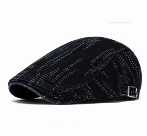 Black denim newsboy cap with adjustable silver metal buckle and textured fabric