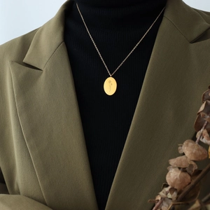 Gold oval flower pendant necklace with fine floral engraving on minimalist thin O-chain
