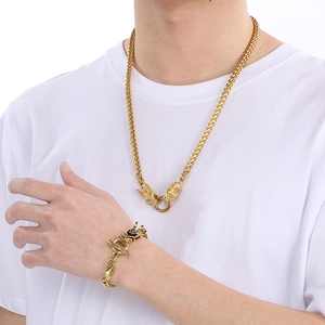 Detailed close-up of golden stainless steel dragon bone necklace and bracelet set on model