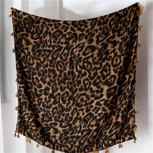 Detailed view of leopard print scarf with soft fringe edges and classic animal pattern