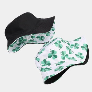 Reversible bucket hat with clover print and solid black design for outdoor fashion