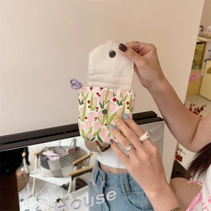 Detail of floral mini storage bag with tulip pattern and snap button closure
