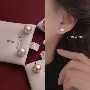 Detailed comparison of 7mm white freshwater pearl earrings on display and worn by a model