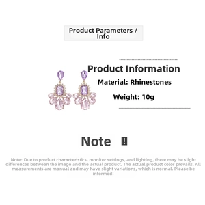 Detail of luxury gold drop earrings with pear-shaped and rectangular purple crystals