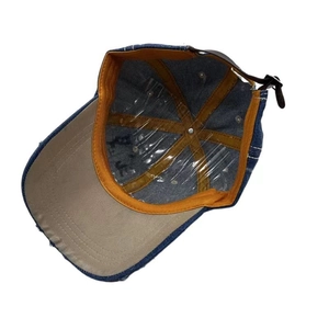 Deep blue denim baseball cap showing orange sweatband and brown leather strap details