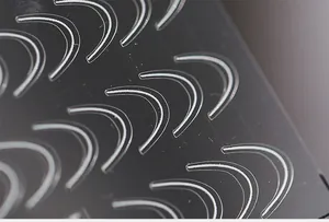 Macro shot of thin transparent French nail stickers with gradient texture on black background