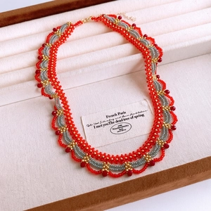 Handcrafted woven glass bead necklace featuring vintage red and gold palace style pattern