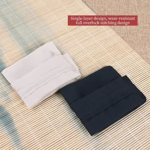 Black and white canvas drawstring jewelry pouches with reinforced lockstitching on bamboo