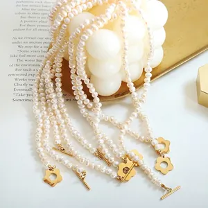 Baroque freshwater pearl necklace with golden flower OT buckle on elegant background