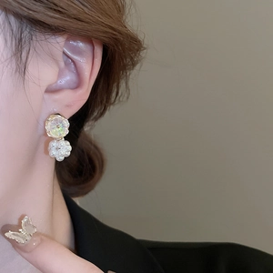 Elegant floral stud earrings with faux pearl cluster on female ear for a chic look