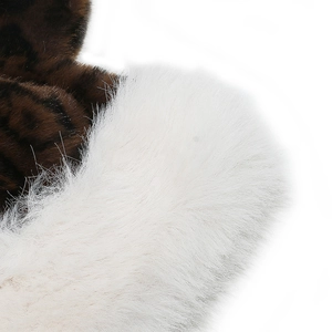 Close-up of leopard print and white faux fur texture on warm plush winter hats