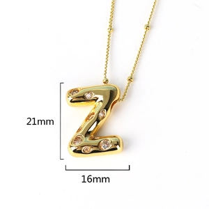 Detailed view of gold letter Z pendant necklace with white stones measuring 21x16mm
