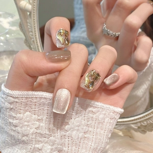 Handmade cat eye press-on nails with champagne amber rhinestones and glitter finish