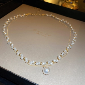 Elegant gold-plated pearl necklace with crown zircon detail and large pearl pendant